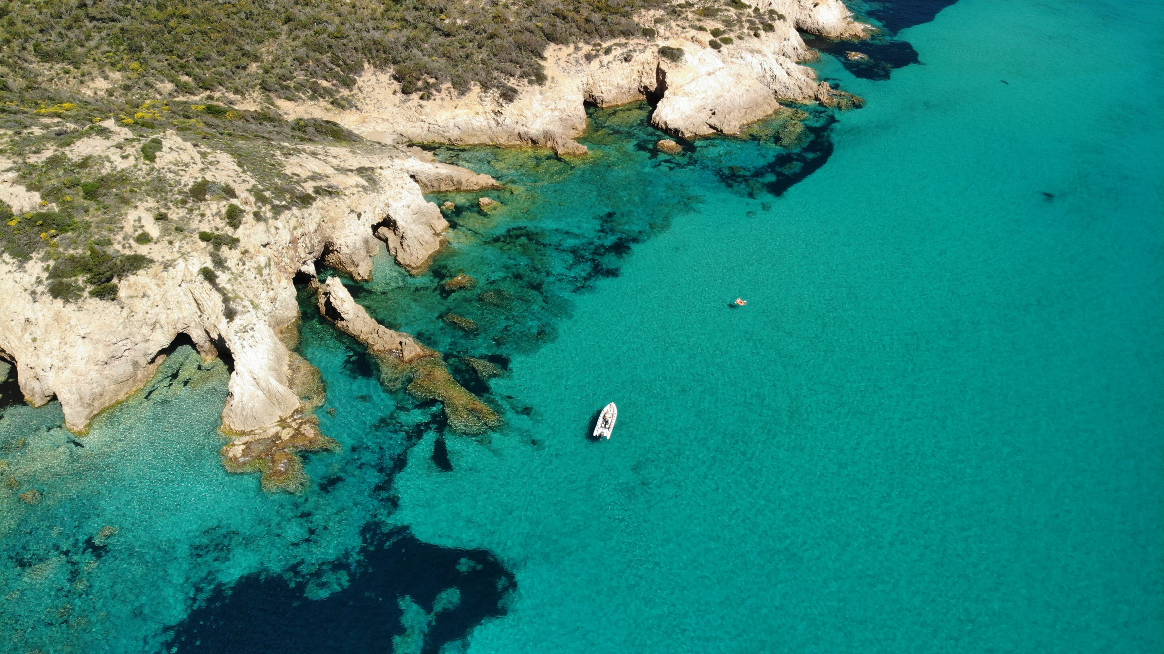 Aerial view of Sardinian coastline and cliffs at midday