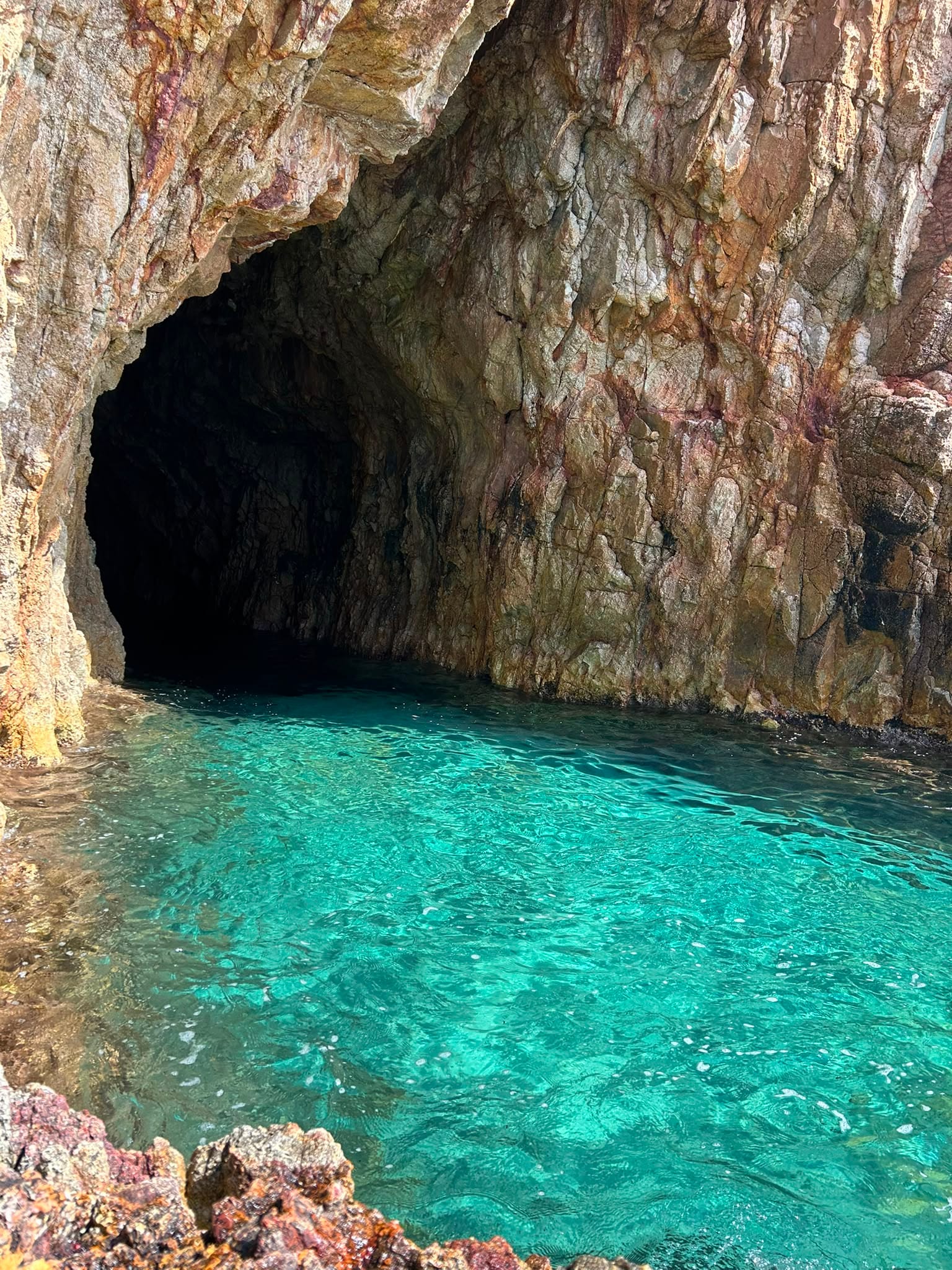 Looking into a sea grotto with crystal-clear turquoise water