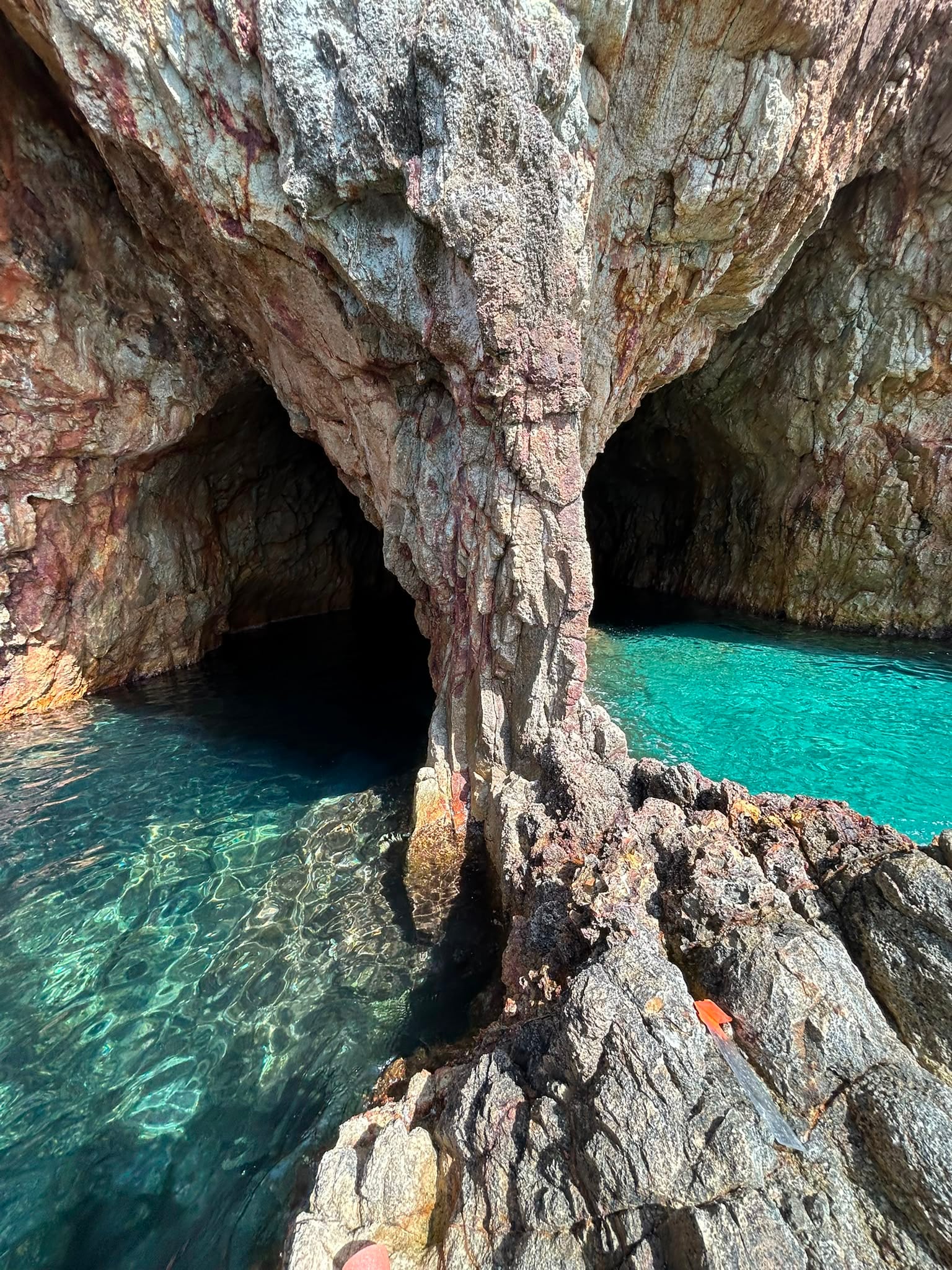 Rock pillar inside the grotto framing two water openings